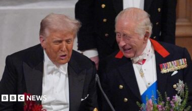 King Charles and US President Donald Trump are sat next to one another at a formal banquet.