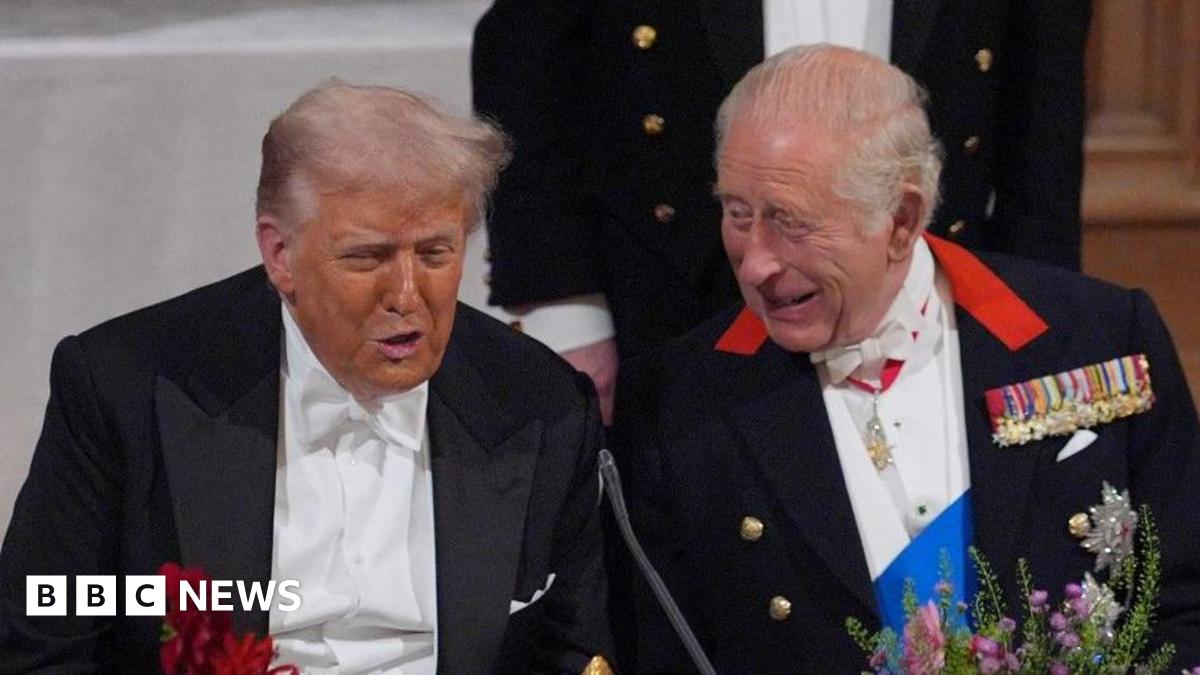King Charles and US President Donald Trump are sat next to one another at a formal banquet.