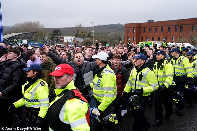 Crystal Palace fans are escorted into the Amex by police ahead of kick-off