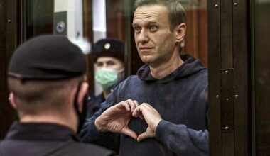 Russian opposition leader Alexei Navalny makes a heart with his hands as he appears in court in Moscow on February 2, 2021