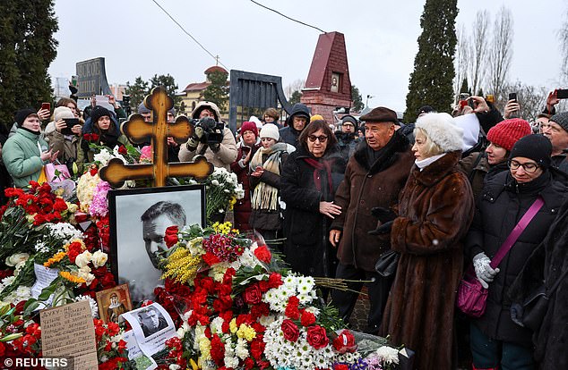 Russian opposition leader Alexei Navalny's parents Anatoly and Lyudmila, accompanied by Alla Abrosimova, who is the mother of Navalny' widow Yulia Navalnaya, come to Navalny's grave to mark the first anniversary of his death at a cemetery in Moscow in February 2025