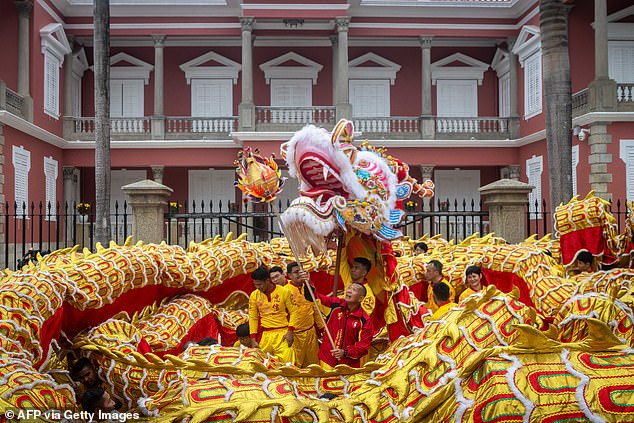 Performers taking part in a 238-meter-long dragon dance in front of the Government Palace during celebrations on the first day of the Lunar New Year of the Horse in Macau