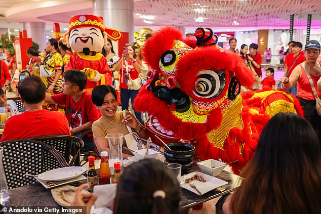 People performing a lion dance at a mall to celebrate the first day of Lunar New Year of the Fire Horse, in Manila, in the Philippines