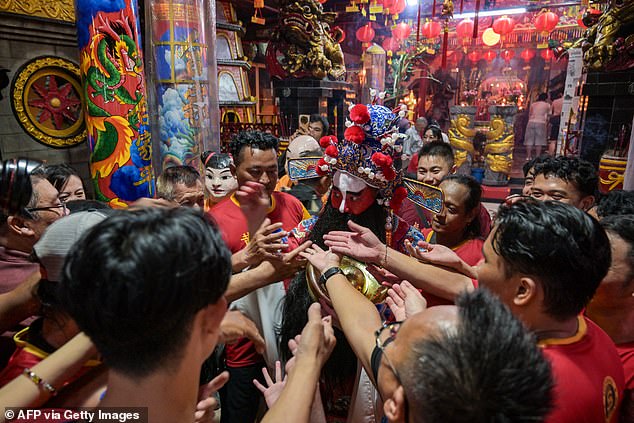People visiting Hong San Koo Tee temple as they take part in the festivities in Surabaya, Indonesia