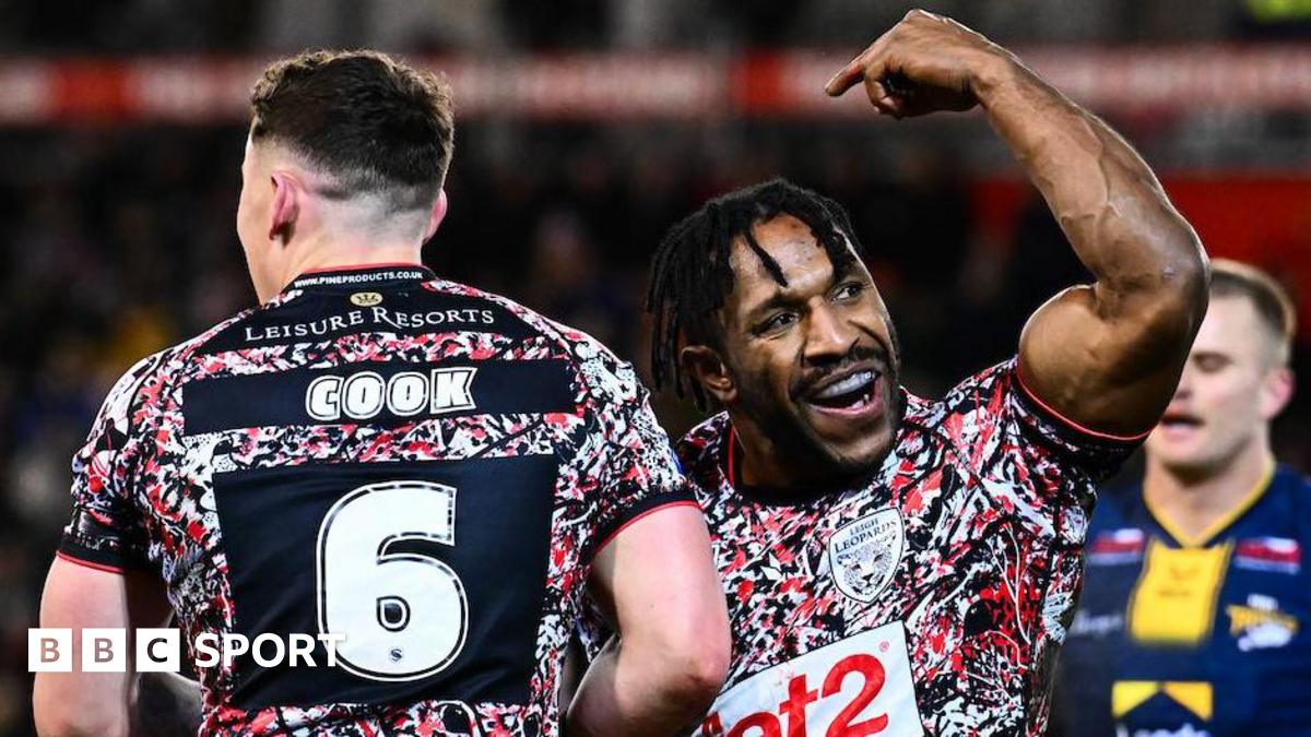 Leigh Leopards player Edwin Ipape celebrates his try against Leeds Rhinos as teammate Adam Cook goes to congratulate him.