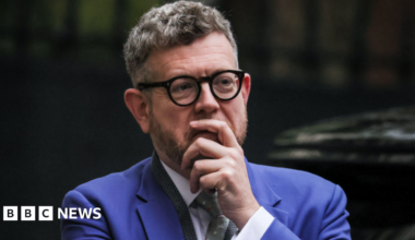 Matthew Doyle wearing a bright blue suit and a white shirt.