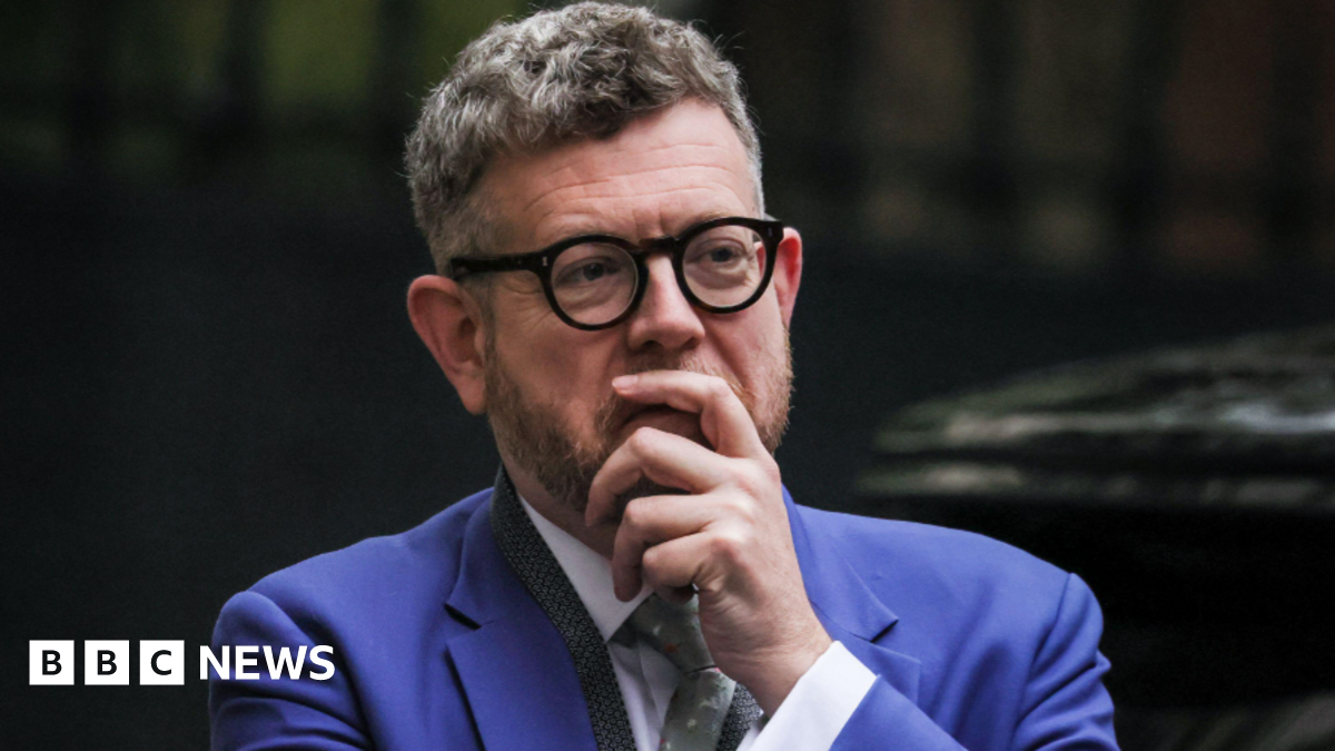 Matthew Doyle wearing a bright blue suit and a white shirt.