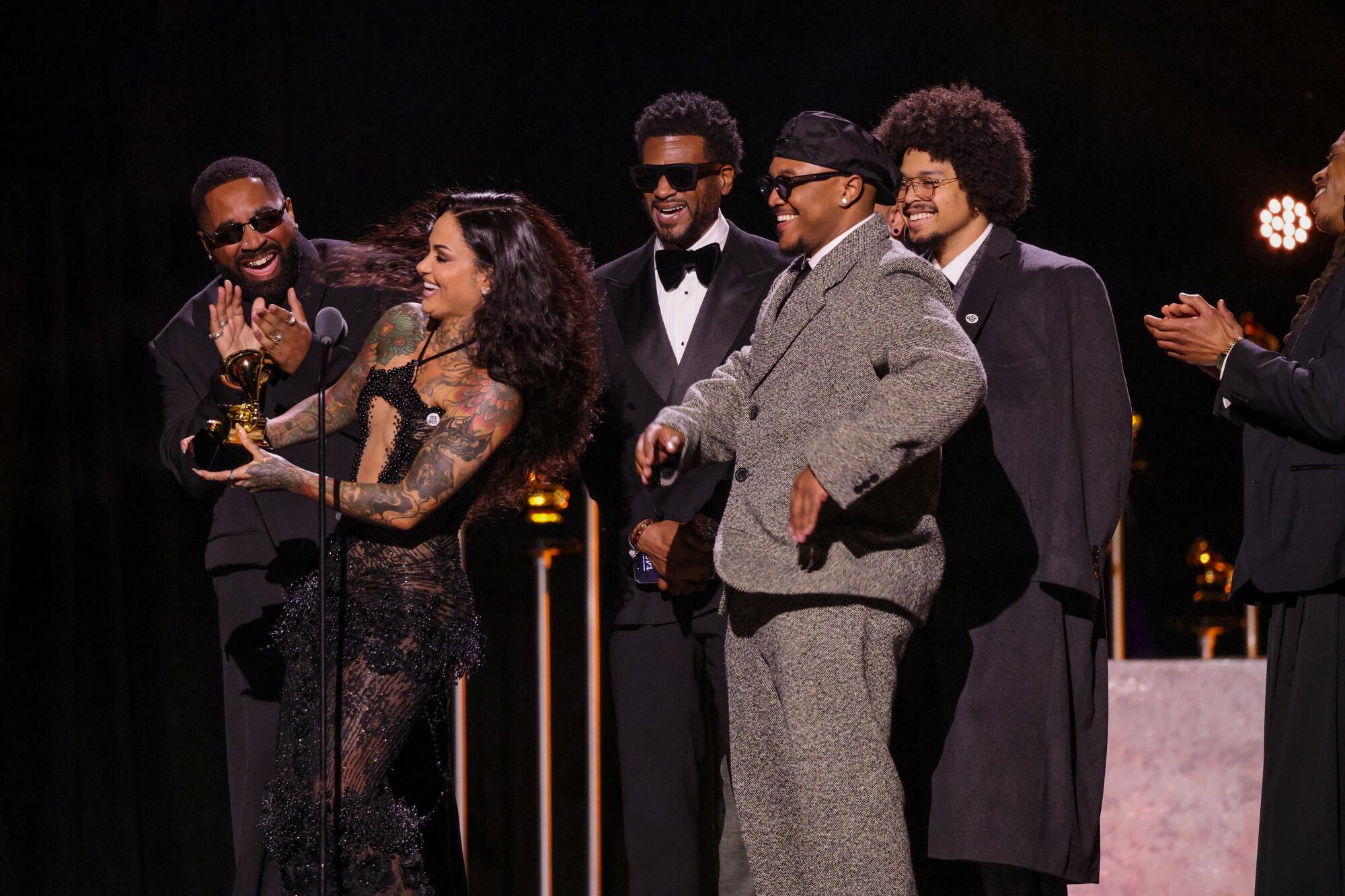 Kehlani accepts a Grammy on stage