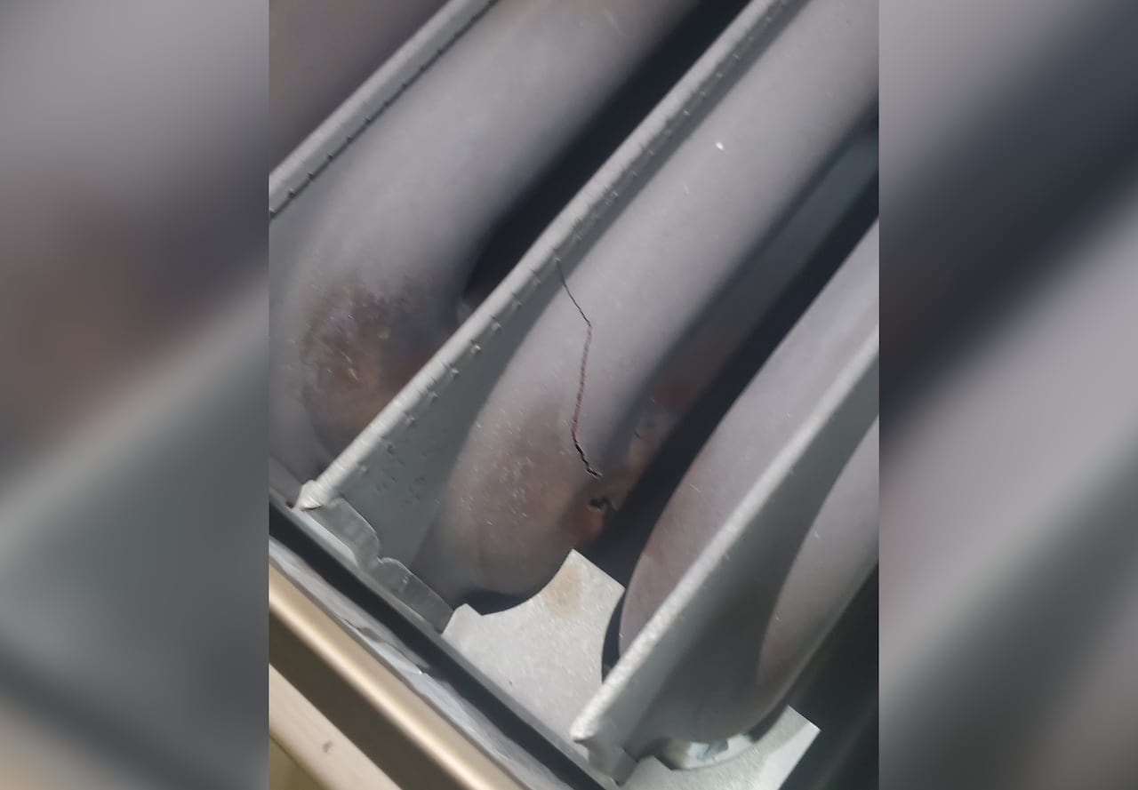 A furnace heat exchanger with a crack showing.