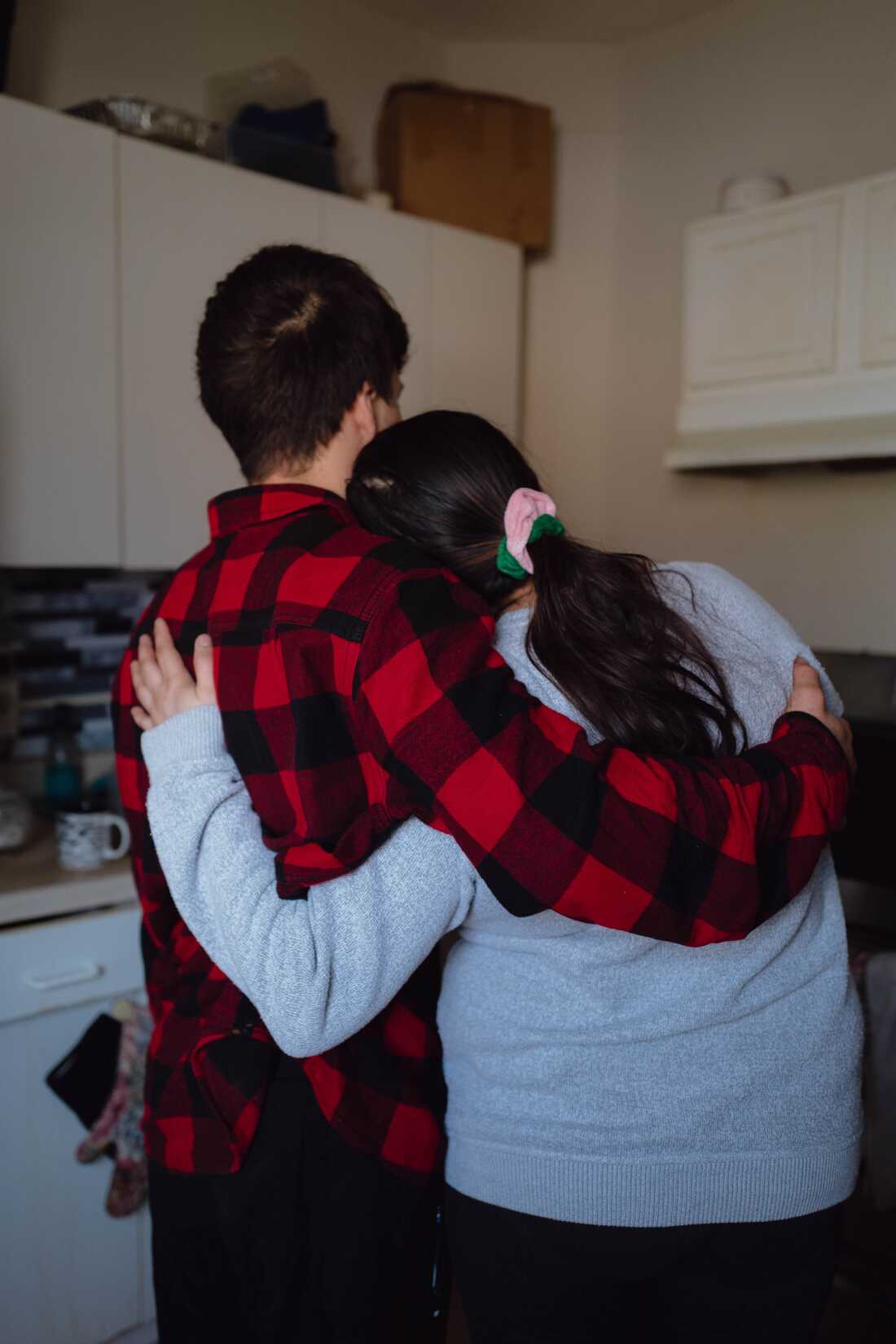 M hugs her son, who was detained by federal agents a few weeks earlier, in Minneapolis. Jan. 26, 2026. Zaydee Sanchez for NPR