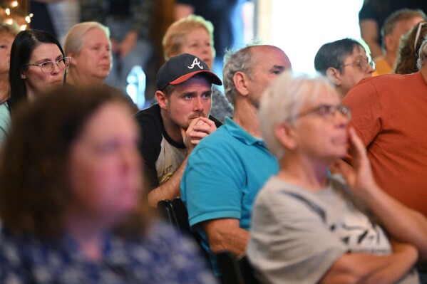 Attendees listen to presentations at the Chatsworth, Ga., town hall on Thursday, June 12, 2025. The group PFAS Georgia represents numerous residents and farmers in Dalton and Calhoun who allege their properties are contaminated with PFAS from the carpet industry. (Hyosub Shin/Atlanta Journal-Constitution via AP)
