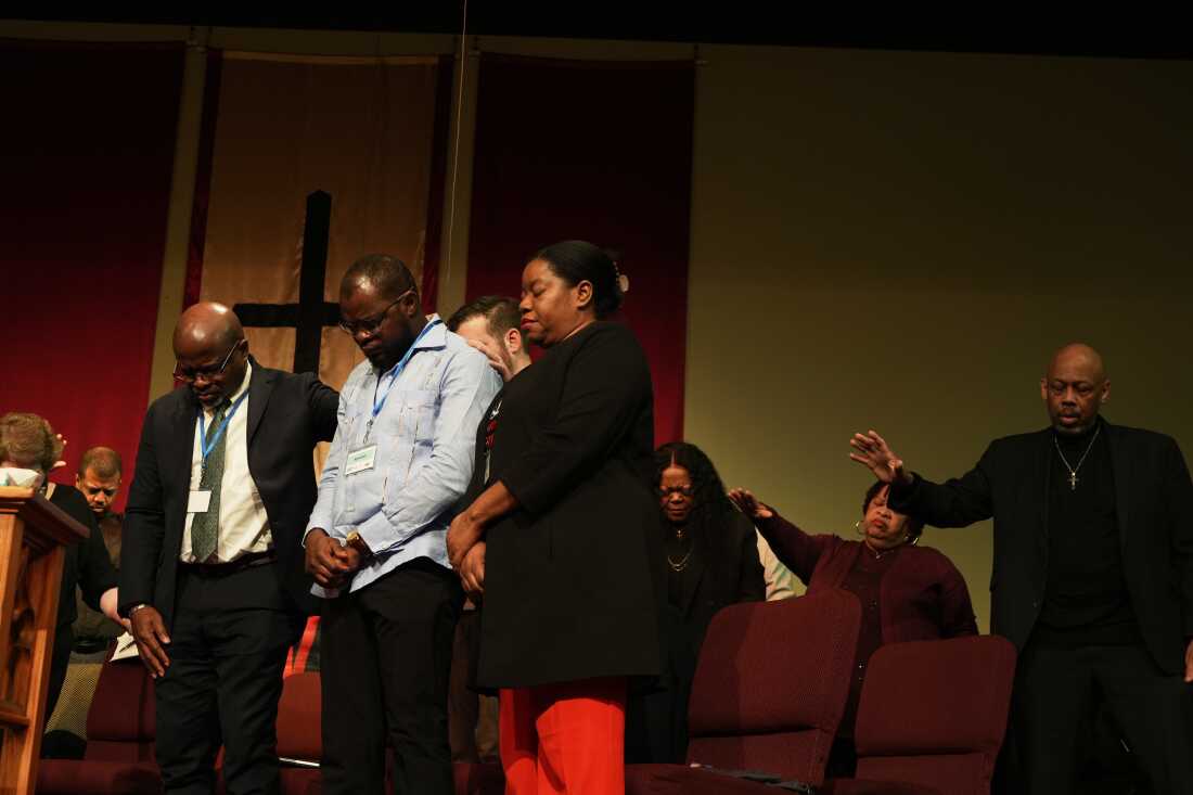 Faith leaders and Haitian community leaders pray at St. John Missionary Baptist Church in Springfield, Ohio, Monday, Feb. 2, 2026, during an event in support of Haitian migrants fearing the end of their Temporary Protected Status in the U.S.