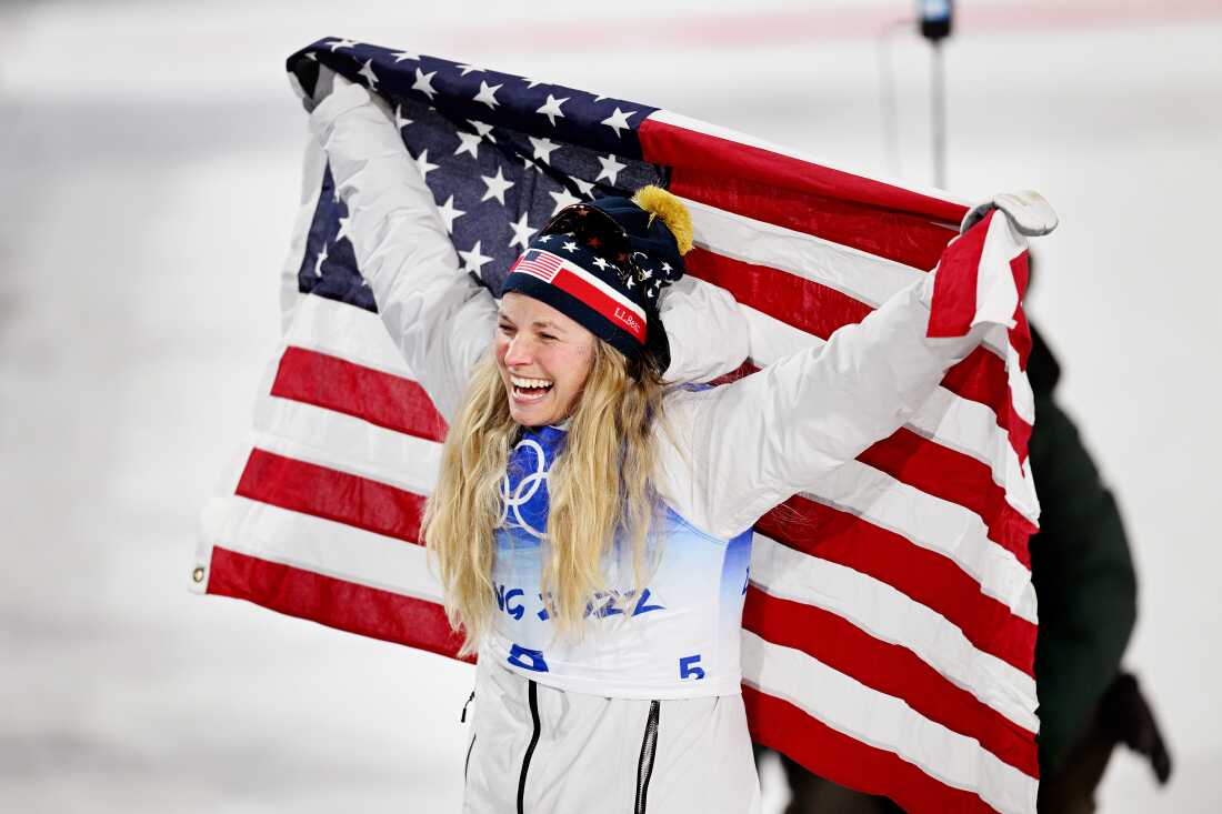 ZHANGJIAKOU, CHINA - FEBRUARY 08: Bronze medallist, Jessie Diggins of Team United States celebrates with a flag during the Women's Cross-Country Sprint Free Final flower ceremony on Day 4 of the Beijing 2022 Winter Olympic Games at The National Cross-Country Skiing Centre on February 08, 2022 in Zhangjiakou, China. (Photo by Matthias Hangst/Getty Images)