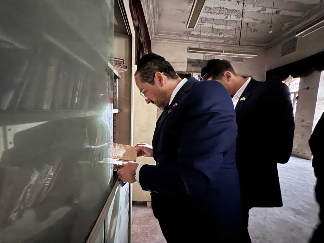Henry Hamra examining religious texts in a small Jewish school in Aleppo, Syria. 