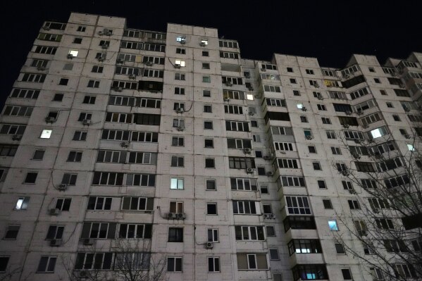 An apartment block is seen during a power outage caused by Russia’s repeated air strikes on the country’s power grid, in Kyiv, Ukraine, Monday, Feb. 2, 2026. (AP Photo/Sergey Grits)