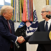 Apple CEO Tim Cook shakes hands with U.S. President Donald Trump 