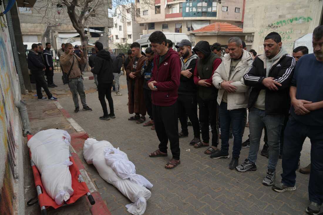 Palestinians mourn over the dead who were killed in an Israeli military strike, at Shifa Hospital in Gaza City, Wednesday, Feb. 4, 2026.