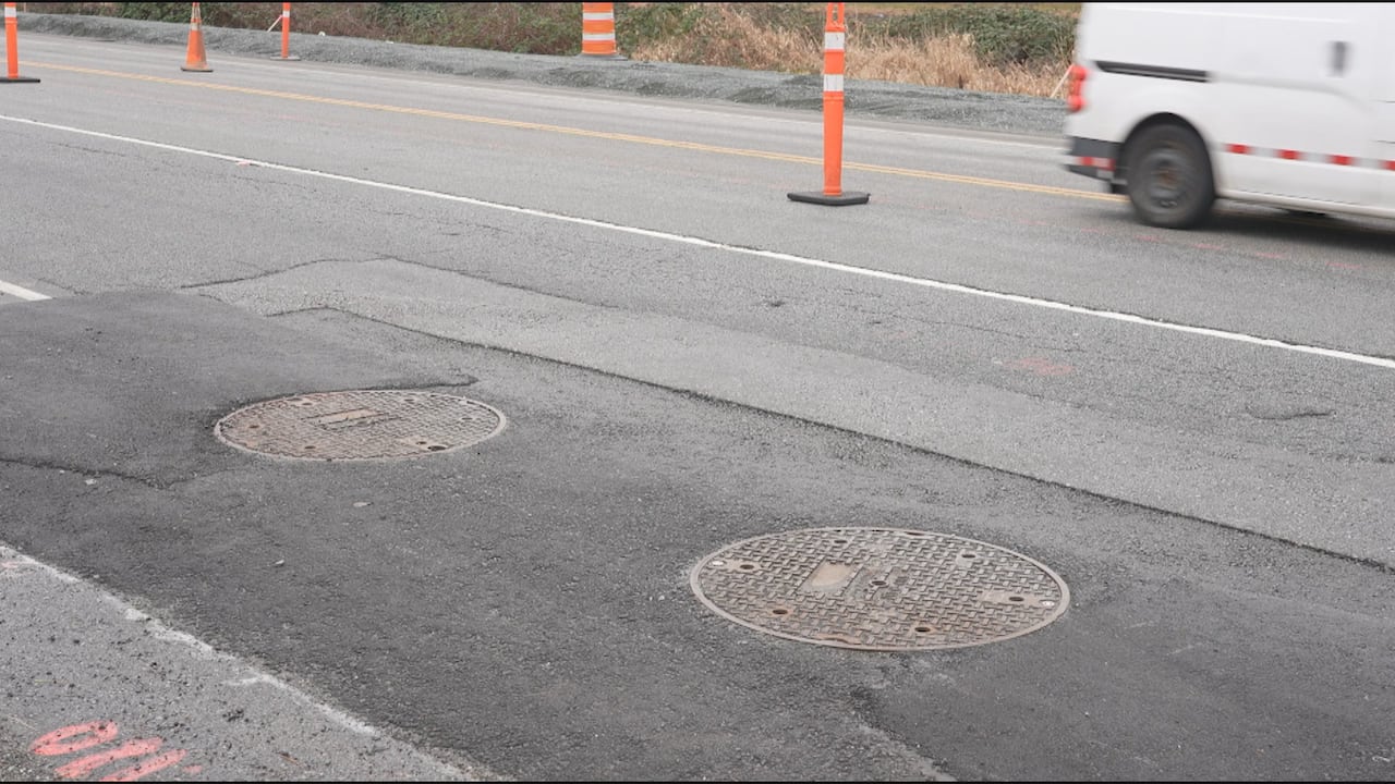 Two manholes on a street.