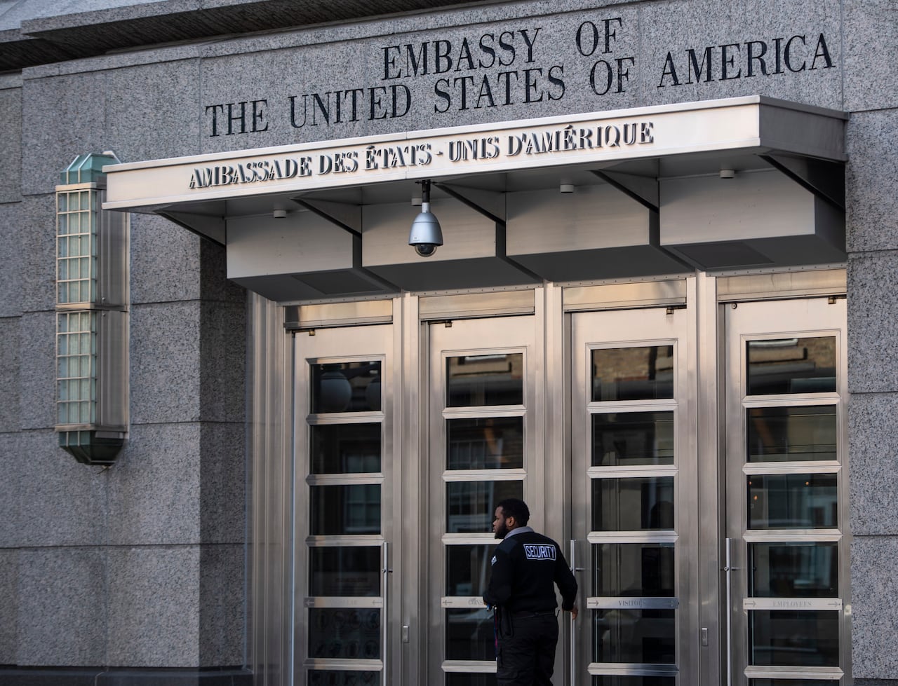 A security guard works outside the Embassy of the United States of America in Ottawa on Saturday, Nov. 7, 2020.