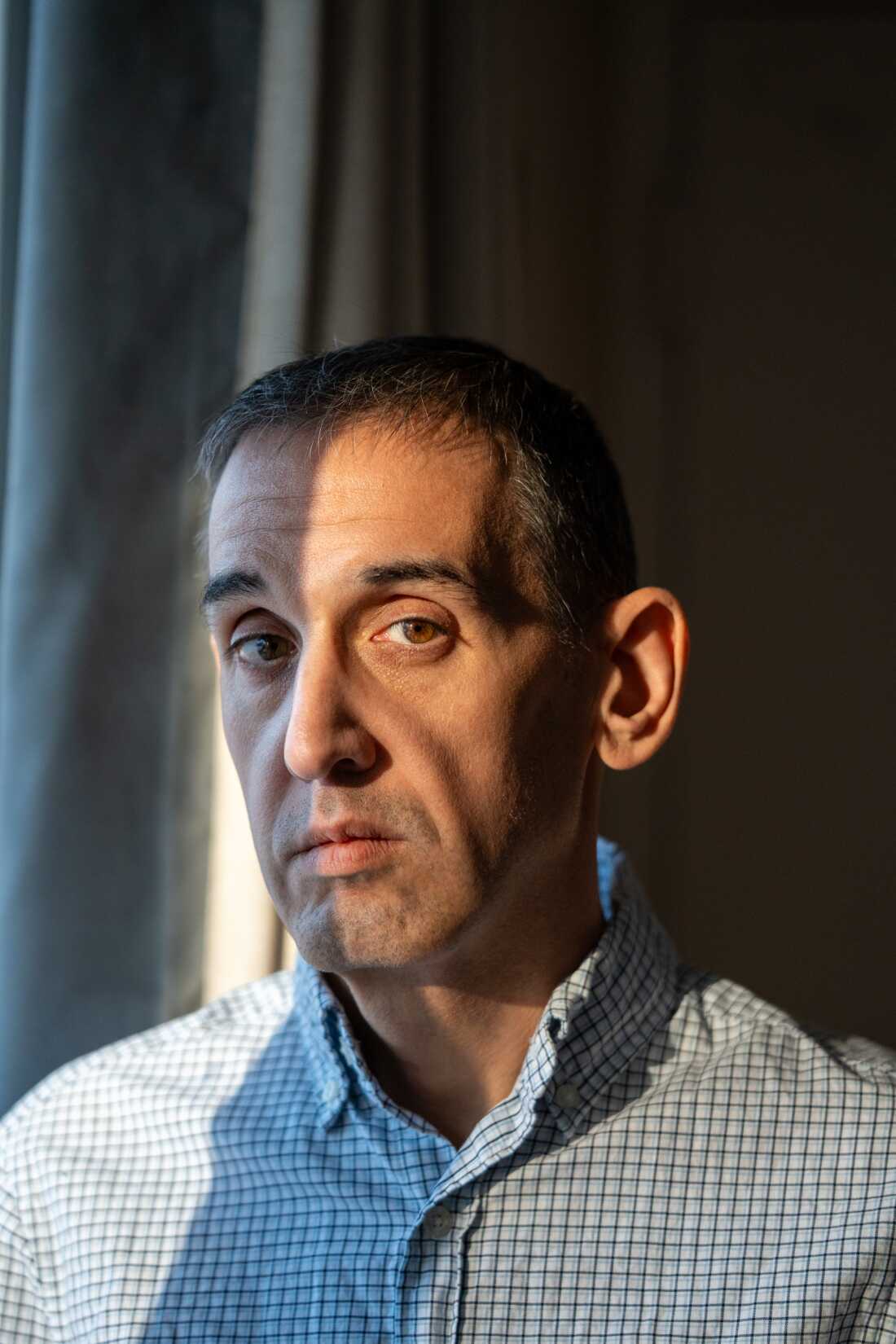 Jason Krynicki's face is shown in a close up portrait. He has a serious expression.