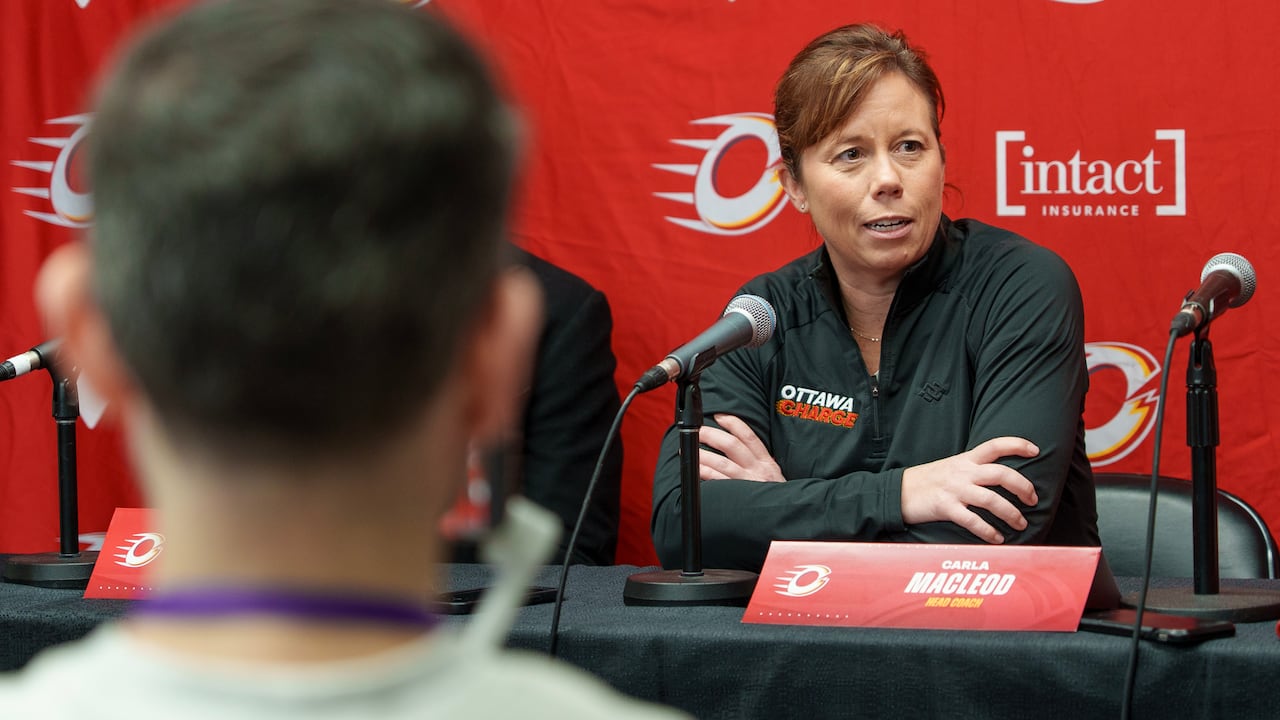 A woman at a press conference. 
