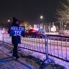 A protester with an anti-ICE sign, stands outside of the Henry Bishop Whipple Federal building on Jan. 18 in Minneapolis, Minn.