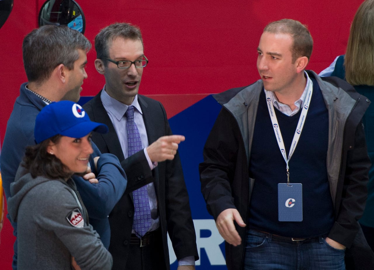 Senior Conservative staffer Ray Novak, centre, is pictured with another staffer, Dennis Matthews, right, as party leader Stephen Harper addresses a campaign rally in Abbotsford, B.C. Sunday, Oct. 18, 2015.