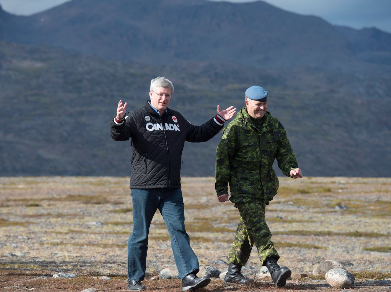 Prime Minister Stephen Harper speaks with Commander Joint Task Force North Brig. Gen. Greg Loos as they make there way to speak to troops Tuesday August 26, 2014 on Baffin Island near York Sound, Nunavut.