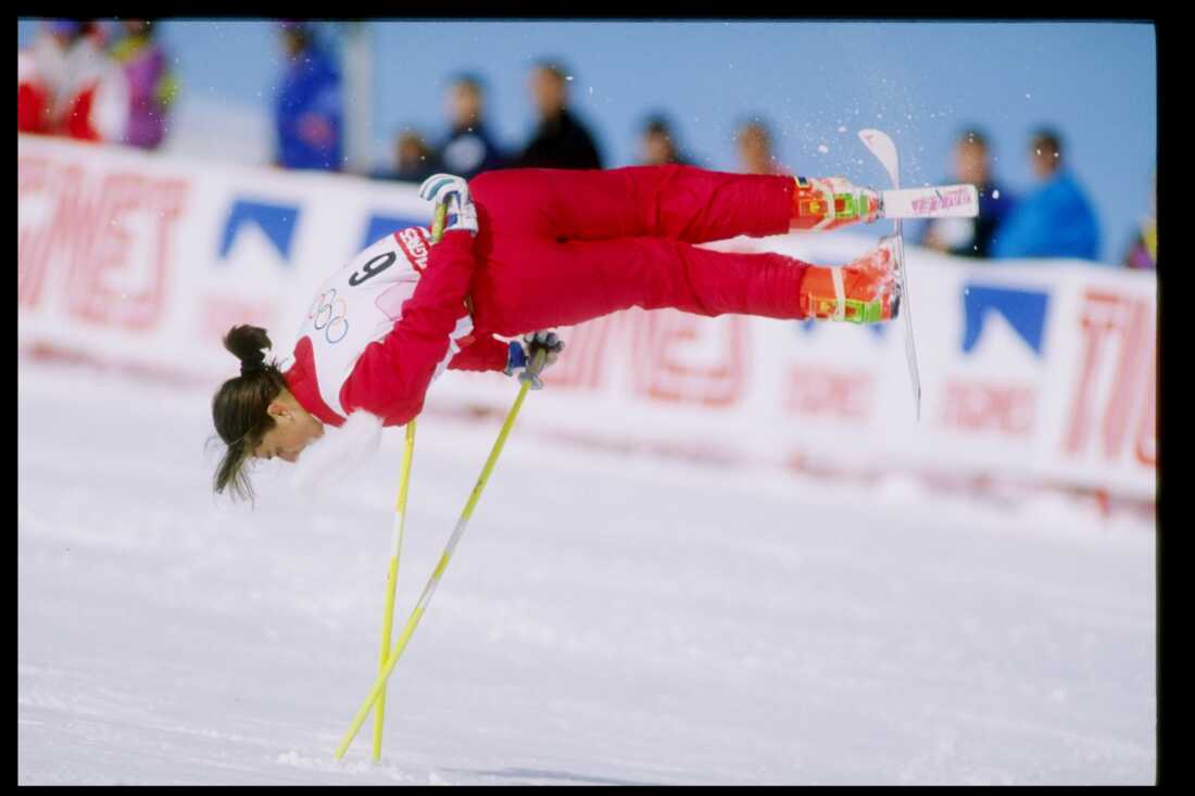Cathy Fechoz of France, wearing a red ski suit, is caught midair while performing her routine during the ski ballet competition at the Olympic Games in Albertville, France, in 1992. 