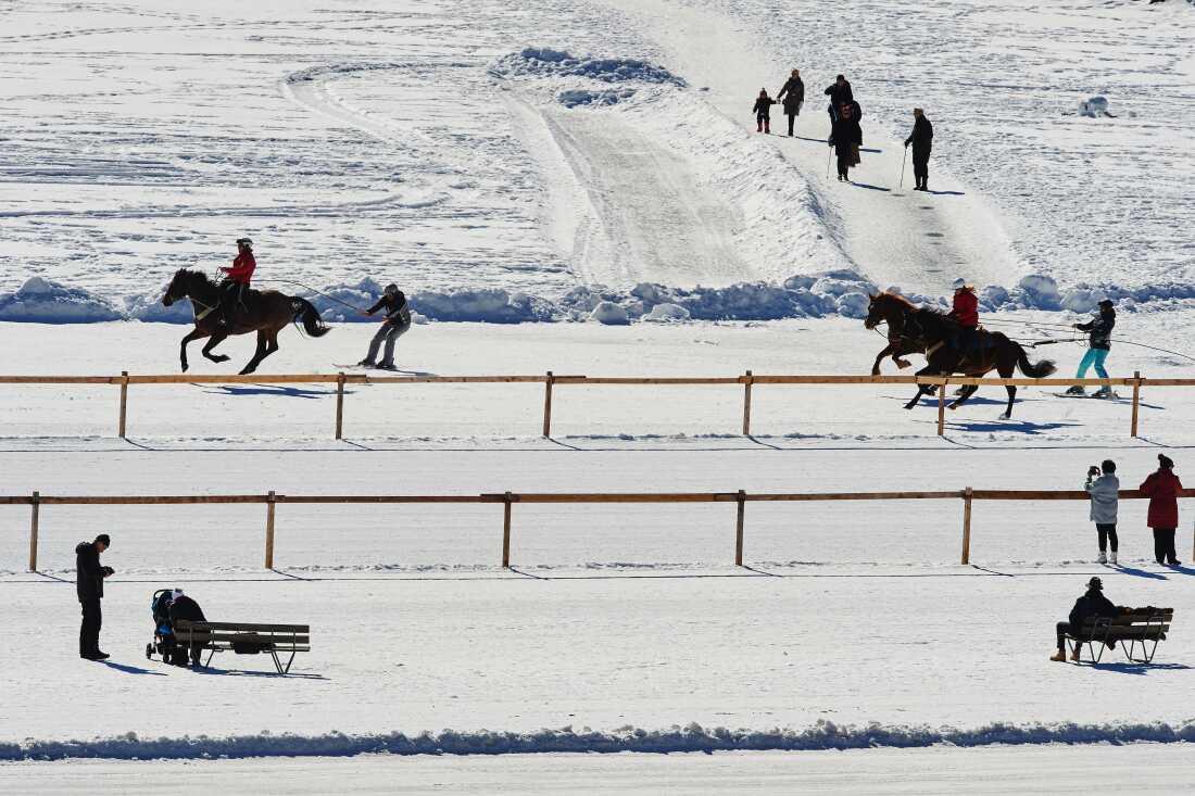 People practice skijoring on the frozen surface of the Lake St. Moritz in 2017. 
