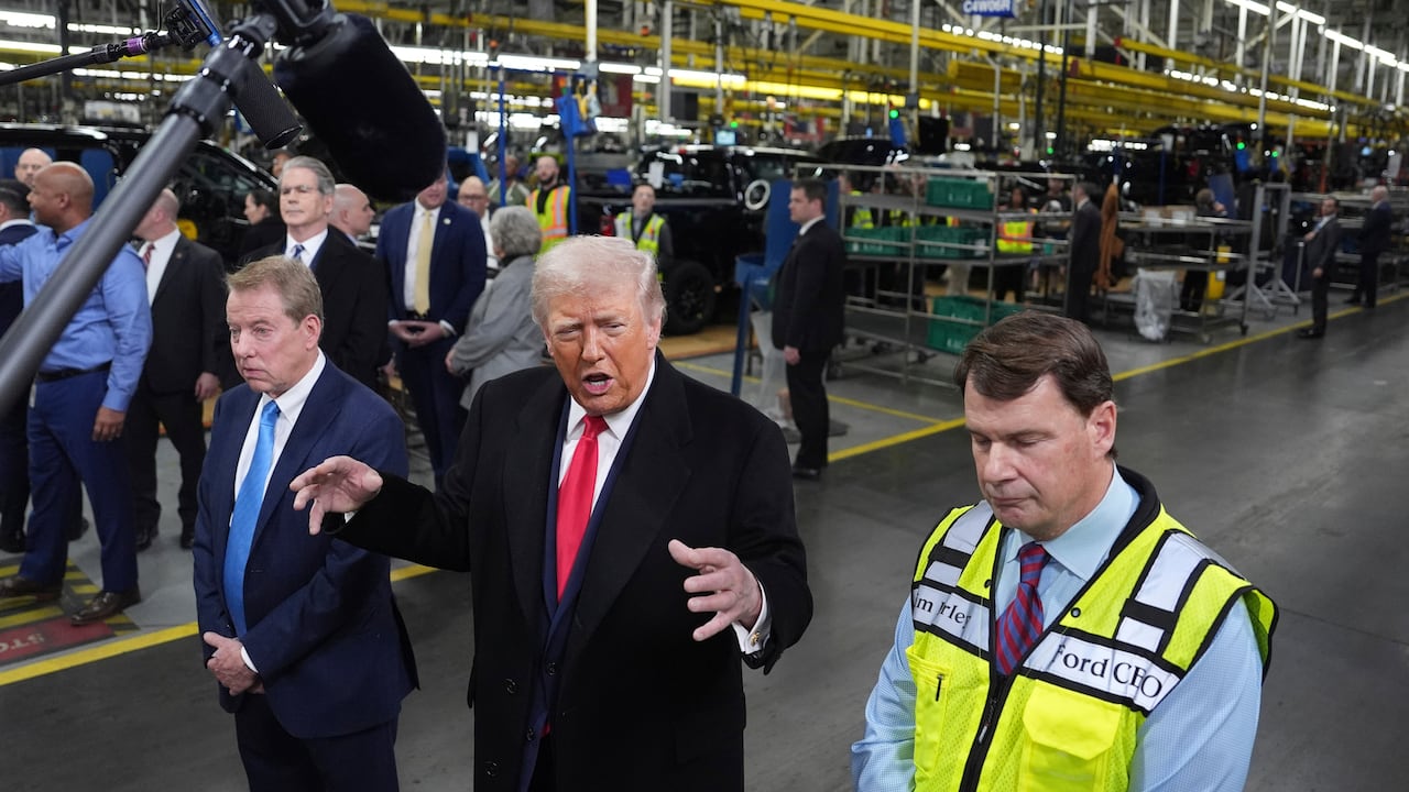President Donald Trump speaks as Bill Ford, executive chairman of Ford, left, and Jim Farley, CEO of Ford, listen during a tour