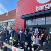 Small group of anti-ICE protesters hold picket signs in front of Target store in Washington, D.C.