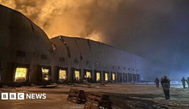 Firefighters work at the site of a Russian drone and missile strike in the city of Yahotyn