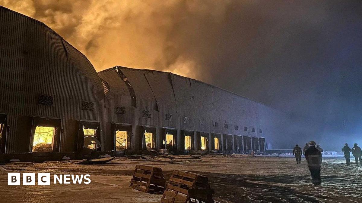 Firefighters work at the site of a Russian drone and missile strike in the city of Yahotyn