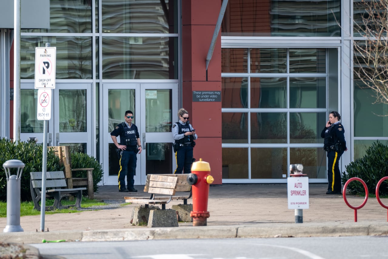 Police wait outside Centennial Secondary in Coquitlam