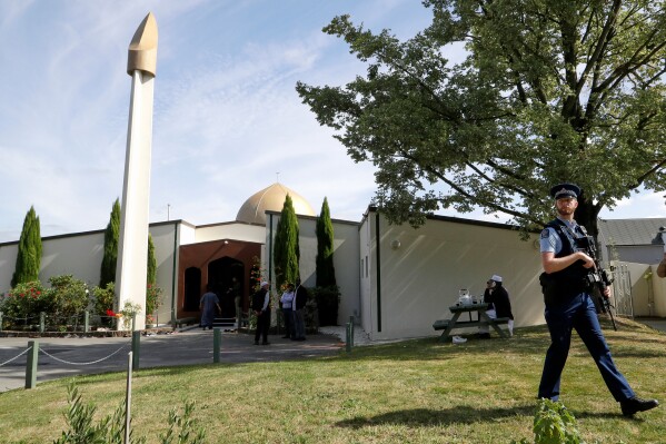 An armed policeman patrols the grounds at the Al Noor mosque March 23, 2019, in Christchurch, New Zealand, following the previous week's mass shooting. (AP Photo/Mark Baker, File)