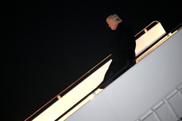 President Donald Trump steps off Air Force One, early Monday, Feb. 9, 2026, at Joint Base Andrews, Md., after returning from a trip to Florida. (AP Photo/Mark Schiefelbein)