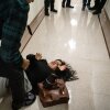 A federal agent pushes the wife of the detained man from Ecuador to the ground on September 25, 2025 in New York City.