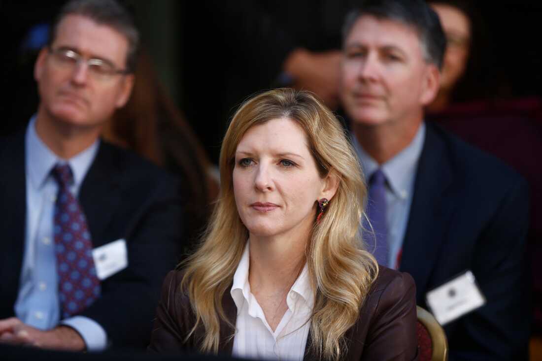 FILE - White House counsel Kathryn Ruemmler listens as President Barack Obama speaks at an installation ceremony for FBI Director James Comey at FBI Headquarters, in Washington, Oct. 28, 2013.