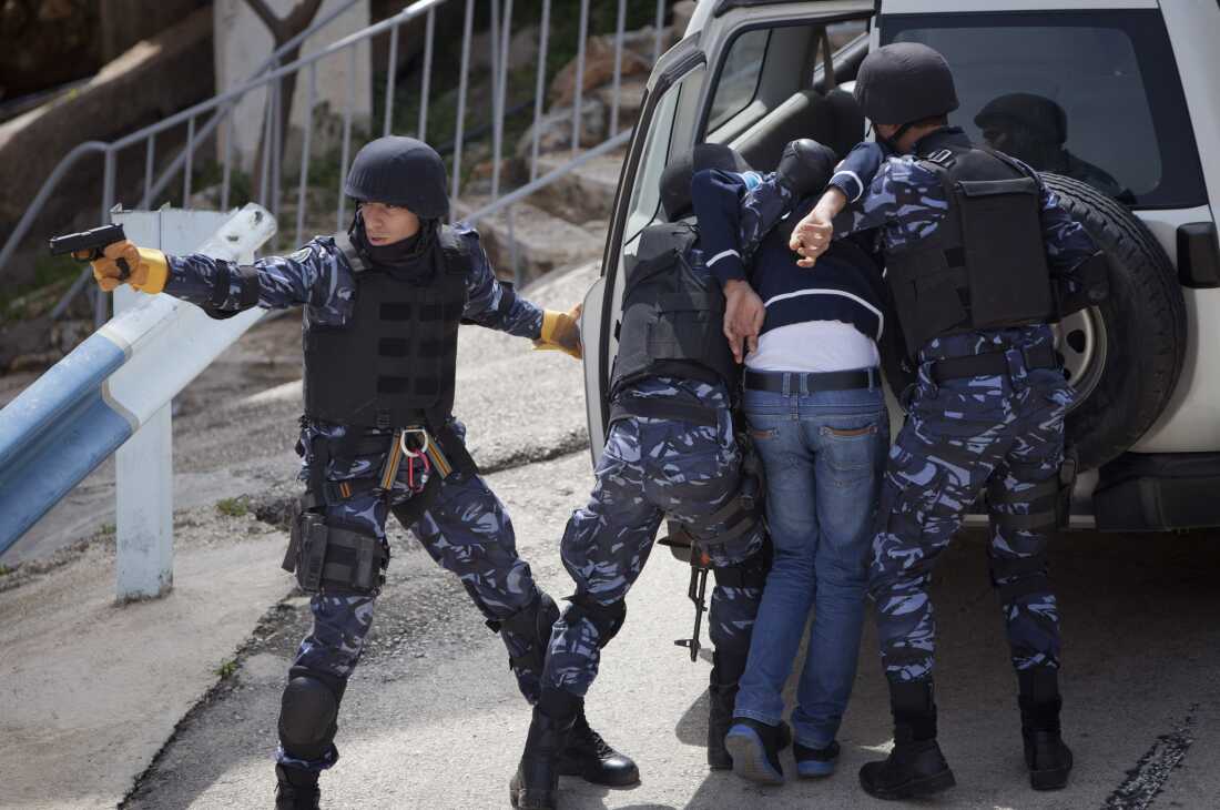 Members of the Palestinian special police force show their skills during a training session in the West Bank city of Ramallah on March 16, 2014.