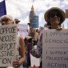 Demonstrators hold placards during a protest in support of the Palestinian People in Gaza, in Parliament Square, in London, Saturday, Aug. 9, 2025.
