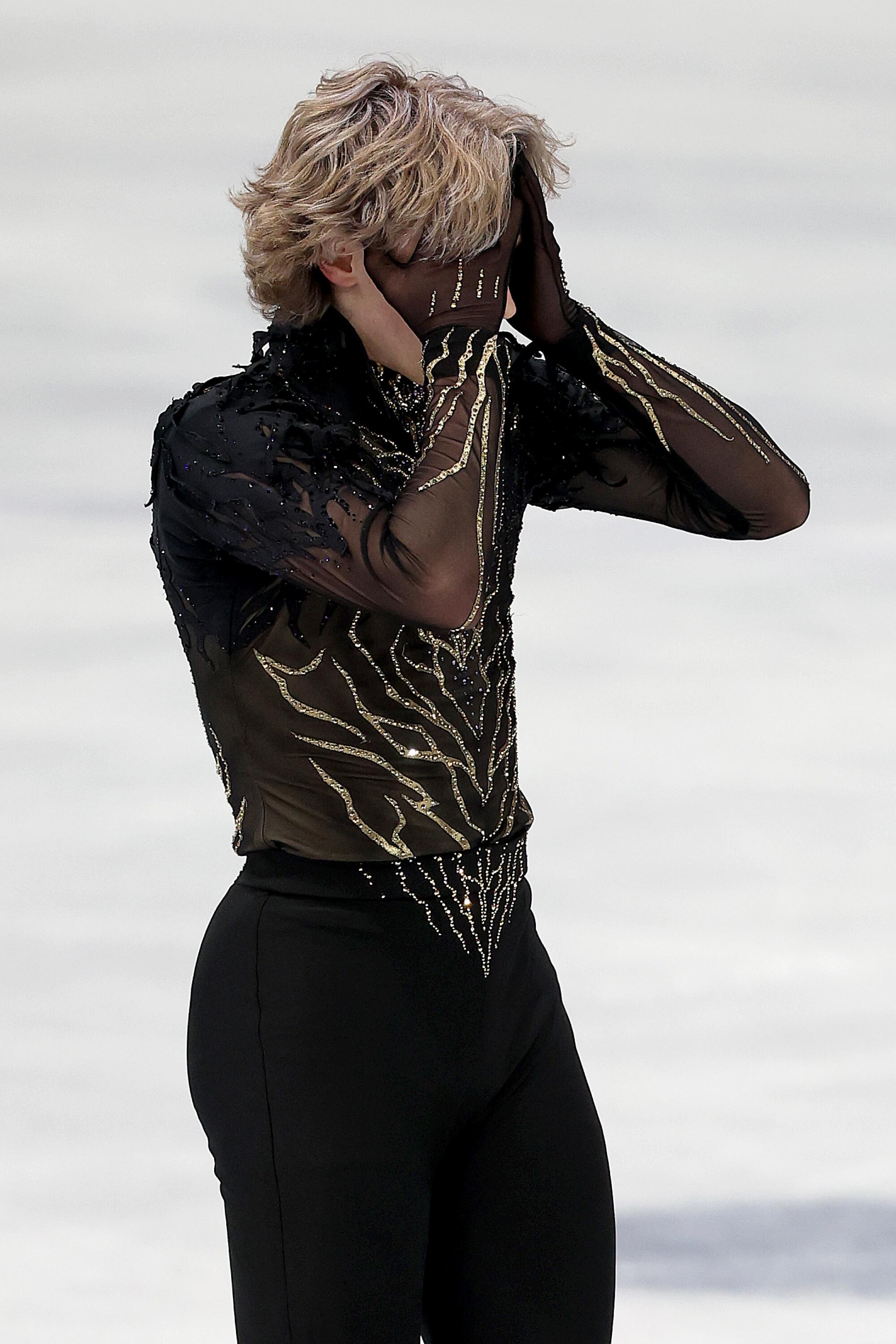 American Ilia Malinin reacts after stumbling through the men's singles free skate at the Winter Olympics on Friday.