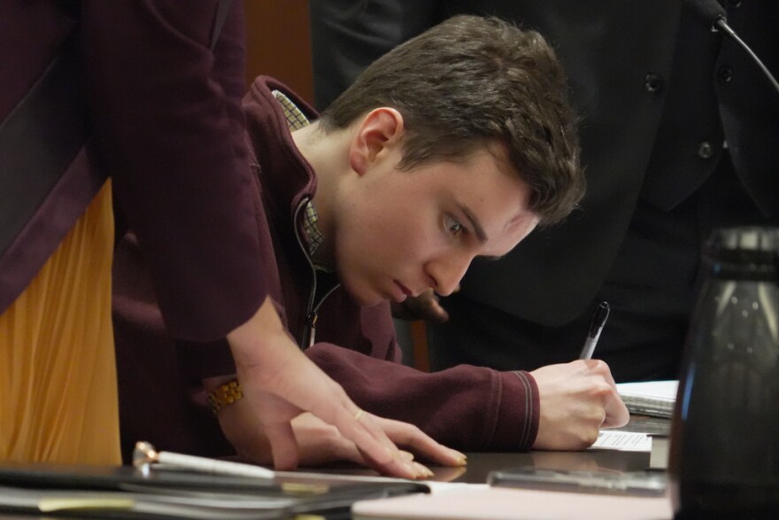 Austin Thompson signs documents pleading guilty to five counts of murder in Wake County Superior Court on Wednesday, Jan. 21, 2026, in Raleigh, N.C. (AP Photo/Allen G. Breed)