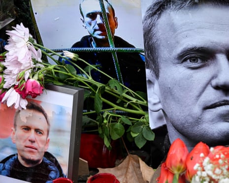 Flowers are seen placed around portraits of late Russian opposition leader Alexei Navalny, who died in a Russian Arctic prison, at a makeshift memorial in front of the former Russian consulate in Frankfurt am Main, western Germany in 2024.