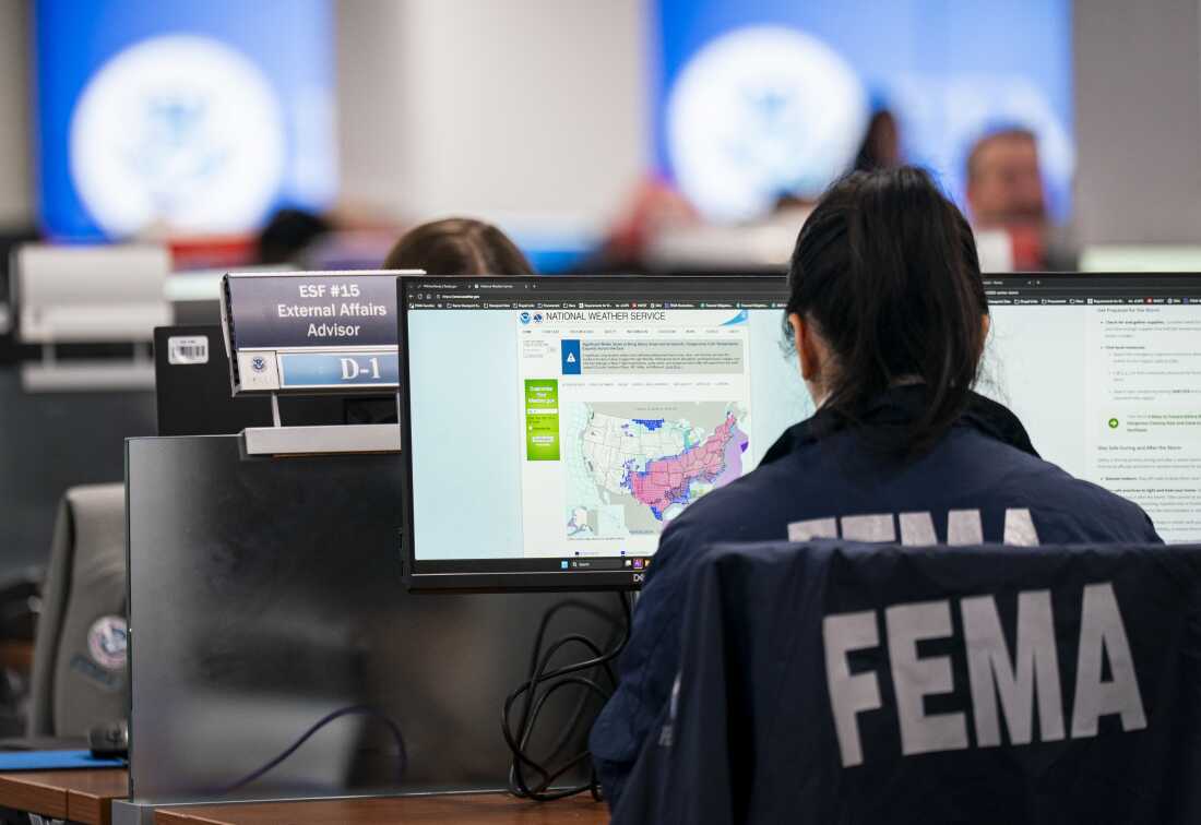 A worker in the National Response Coordination Center looks at a map of the approaching winter storm at FEMA headquarters on January 24, 2026 in Washington, D.C.