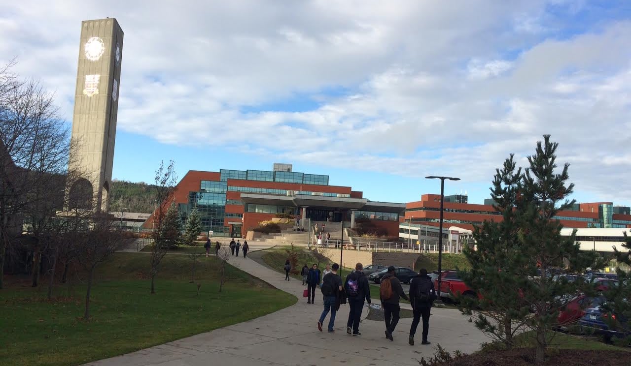 People walk outside a building.