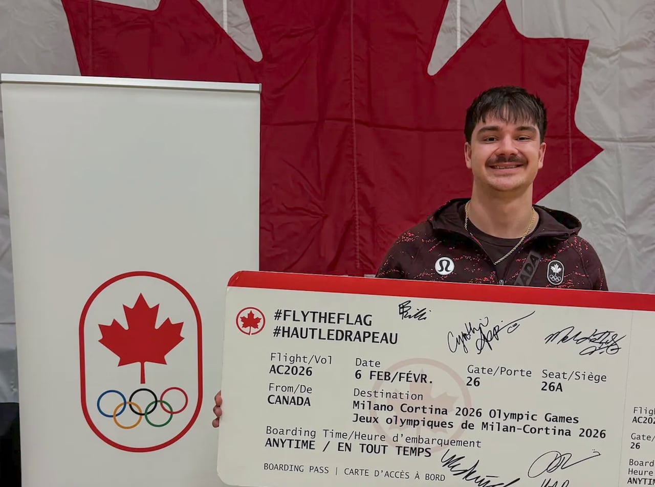 man holding big check in front of canadian flag