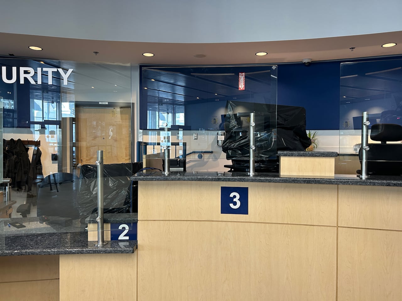 Black plastic bags cover computers.