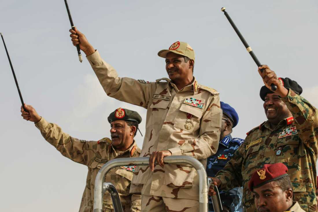 Gen. Mohammed Hamdan Dagalo, center, greets the crowd during a military-backed tribes' rally in the Nile River State of Sudan, on Saturday, July 13, 2019. 