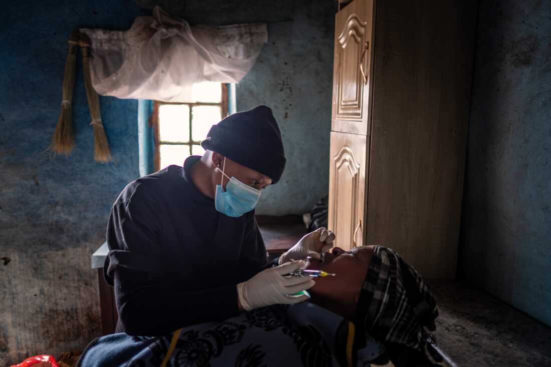 Dental therapist Senate Makhoali of the Lesotho Flying Doctor Services treats a patient during a visit by helicopter to the isolated village of Mphooko in the highlands of Lesotho. The village lies several hours on horseback from the nearest road or clinic.